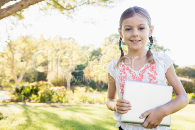 Portrait of girl standing with tablet computer