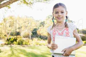 Portrait of girl standing with tablet computer
