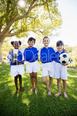 Portrait of children soccer team in raw smiling