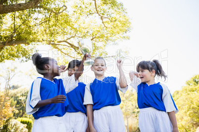 Happy children soccer team celebrating a victory