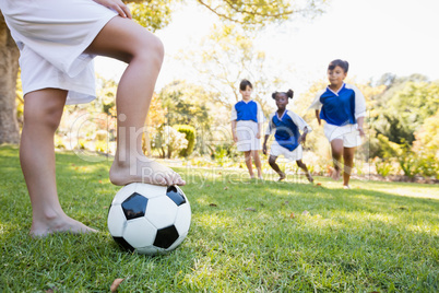 Children wearing soccer uniform playing a match
