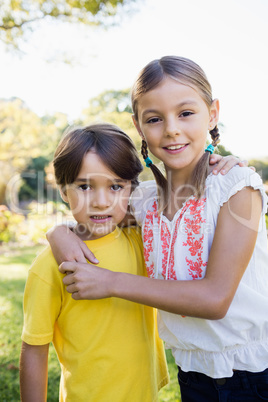 Portrait of brother and sister arm in arm