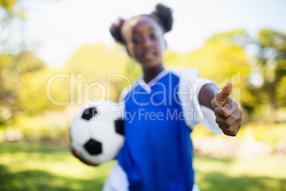 Portrait of girl with thumbs up