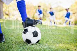 Close up view of balloon under football boots against children p