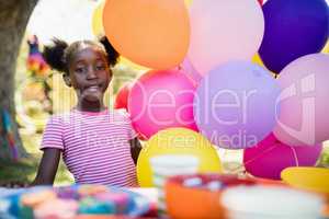 Cute girl posing next to balloon on a birthday party