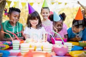 Cute children looking candles during a birthday party