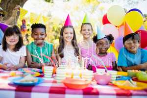 Group of children smiling and posing during a birthday party