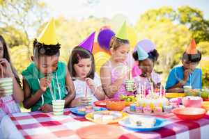 Group of children drinking with straw during a birthday party