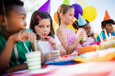 Children drinking with a straw during a birthday party
