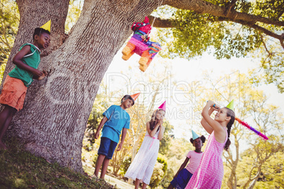 Little girl is going to broke the pinata for her birthday