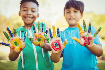 Portrait of two boys showing their hands to the camera