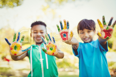 Portrait of two boys showing their hands to the camera