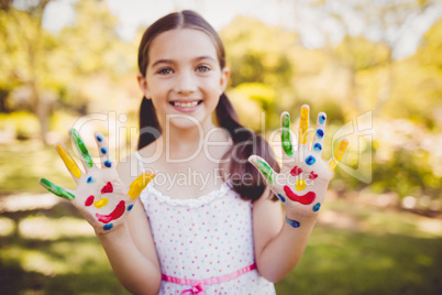 Portrait of a girl with make-up showing her painted hands