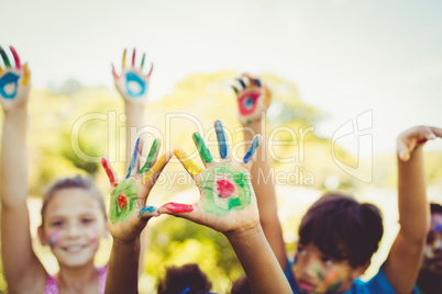 Portrait of cute children with make up having coloured hands