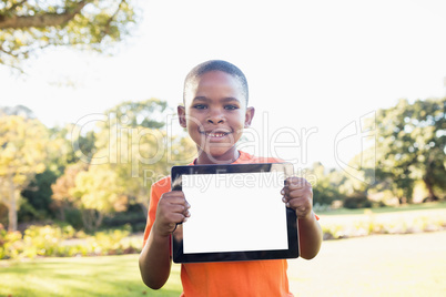 Little boy showing a digital tablet to the camera