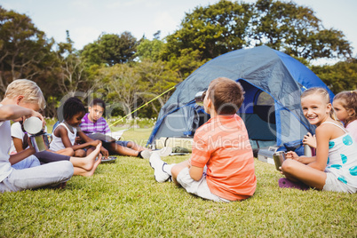 Smiling kids lying on the grass together