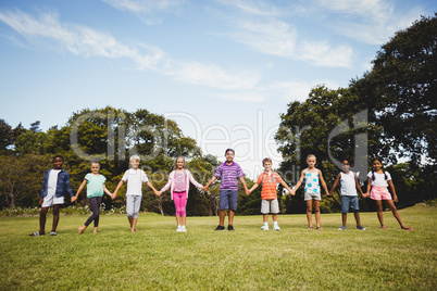 Smiling kids posing together during a sunny day