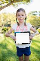 Child holding tablet during a sunny day