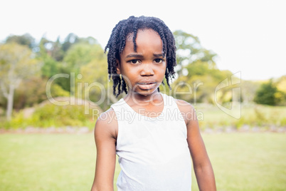 Kid posing at camera during a sunny day