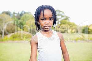 Kid posing at camera during a sunny day