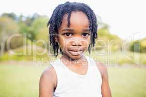 Kid posing at camera during a sunny day