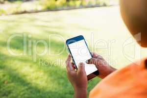 Kid using smartphone during a sunny day