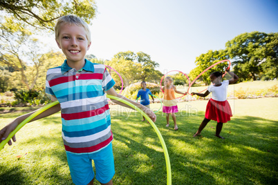 Kids playing hoop together during a sunny day