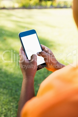 Kid using smartphone during a sunny day