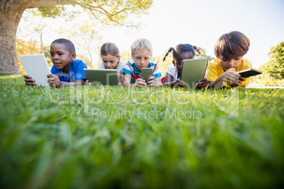 Kids using technology during a sunny day