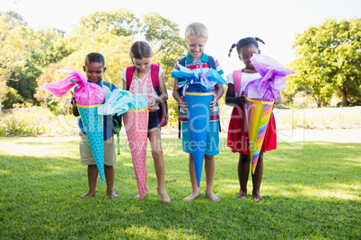 Kids posing with their gift surprise during a sunny day