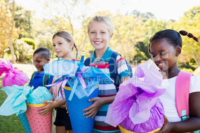 Kids posing with their gift surprise during a sunny day