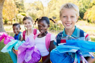 Kids posing with their gift surprise during a sunny day