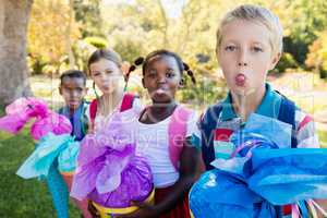 Kids are sticking their tongue out during a sunny day