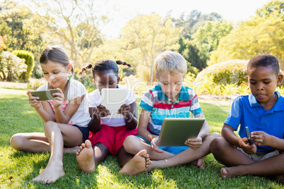 Kids using technology during a sunny day