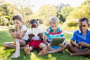 Kids using technology during a sunny day