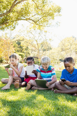 Kids using technology during a sunny day