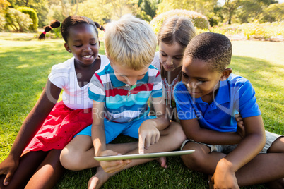 Kids using technology during a sunny day