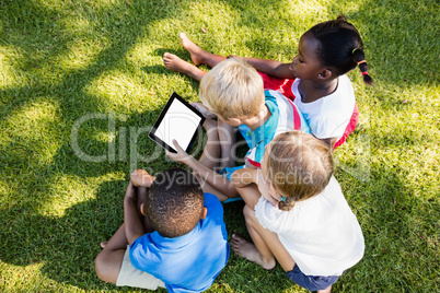 Kids using technology during a sunny day