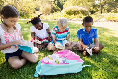 Kids reading books during a sunny day