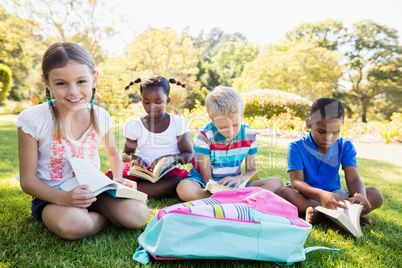 Kids reading books during a sunny day