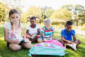 Kids reading books during a sunny day