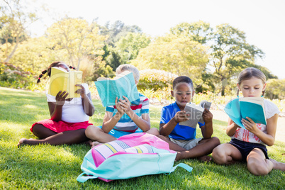 Kids reading books during a sunny day