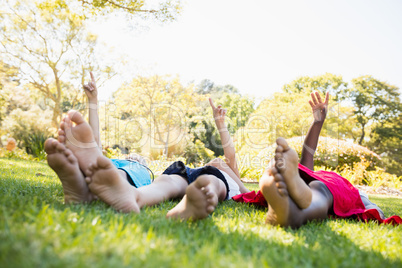 Kids are lying on the grass during a sunny day