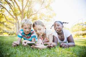 Kids using technology during a sunny day