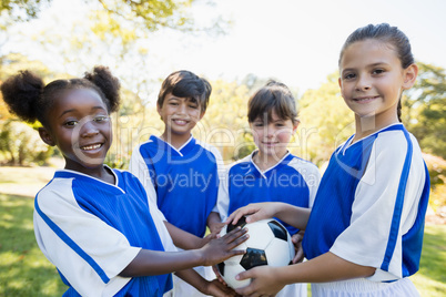 Kids holding balloon during a sunny day