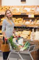 Smiling woman pushing trolley