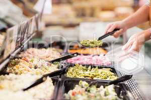 Close up view of hands picking prepared meals