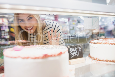 Portrait of woman looking at desserts shelf