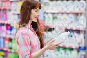 Profile view of woman choosing detergent