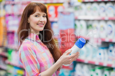 Beautiful woman posing with detergent